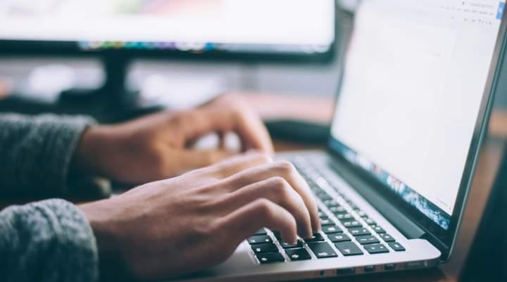 Man's hands on a laptop keyboard 